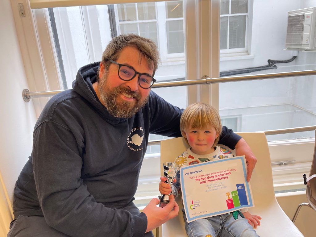 A young boy receiving his OIT certificate